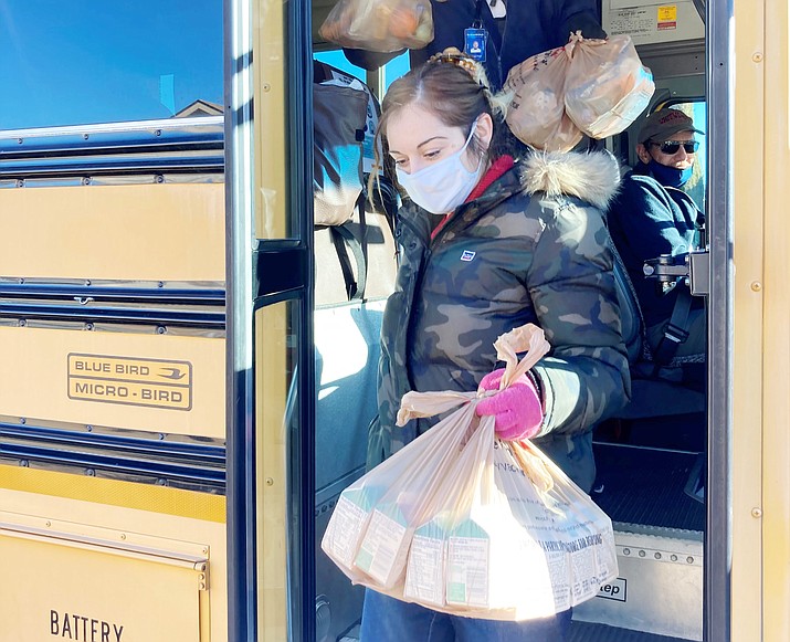 The Humboldt Unified School District Transportation Department “elves” Shawn Floyd and Mari Leithead prepare to deliver meals to one of the first homes on their east Prescott Valley route on Monday, Dec. 21, 2020. (HUSD/Courtesy)
