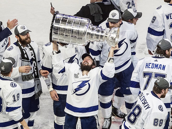 In this Sept. 28, 2020, file photo, Tampa Bay Lightning's Nikita Kucherov (86) hoists the Stanley Cup after defeating the Dallas Stars in the NHL Stanley Cup hockey finals in Edmonton, Alberta. Kucherov is expected to miss the entire regular season because of a hip injury that requires surgery. General manager Julien BriseBois ruled out Kucherov for the 56-game season that begins Jan. 13 and ends May 8. (Jason Franson/The Canadian Press via AP, File)