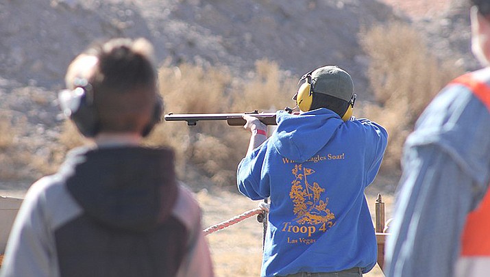 The Church of Jesus Christ of Latter-day Saints was hit with several lawsuits Monday for allegedly covering up decades of sexual abuse among Boy Scout troops in Arizona, marking the latest litigation before the state’s end-of-year deadline for adult victims to sue.
Boy Scouts are shown above shooting a blackpowder rifle at a jamboree. (Photo by Noah Wulf, cc-by-sa-4.0, https://bit.ly/3nJz86X)
