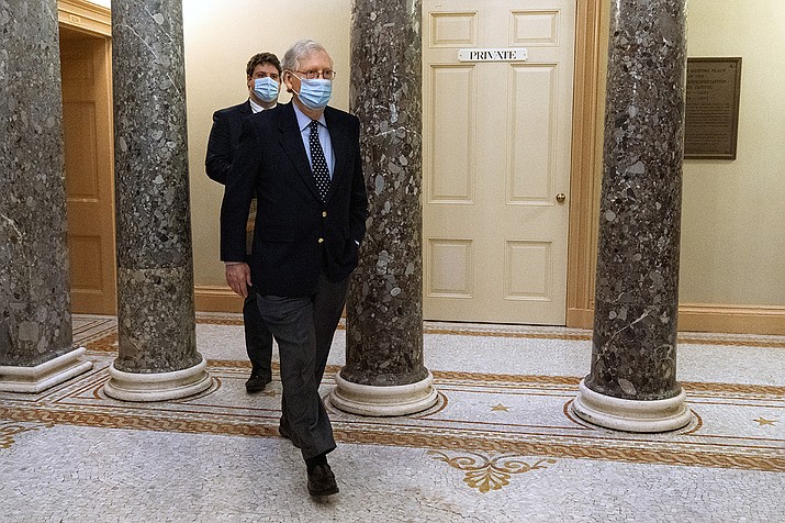 Followed by a staffer, Senate Majority Leader Mitch McConnell of Ky., right, leaves the Capitol for the day, Tuesday, Dec. 29, 2020, on Capitol Hill in Washington. (Jacquelyn Martin/AP)