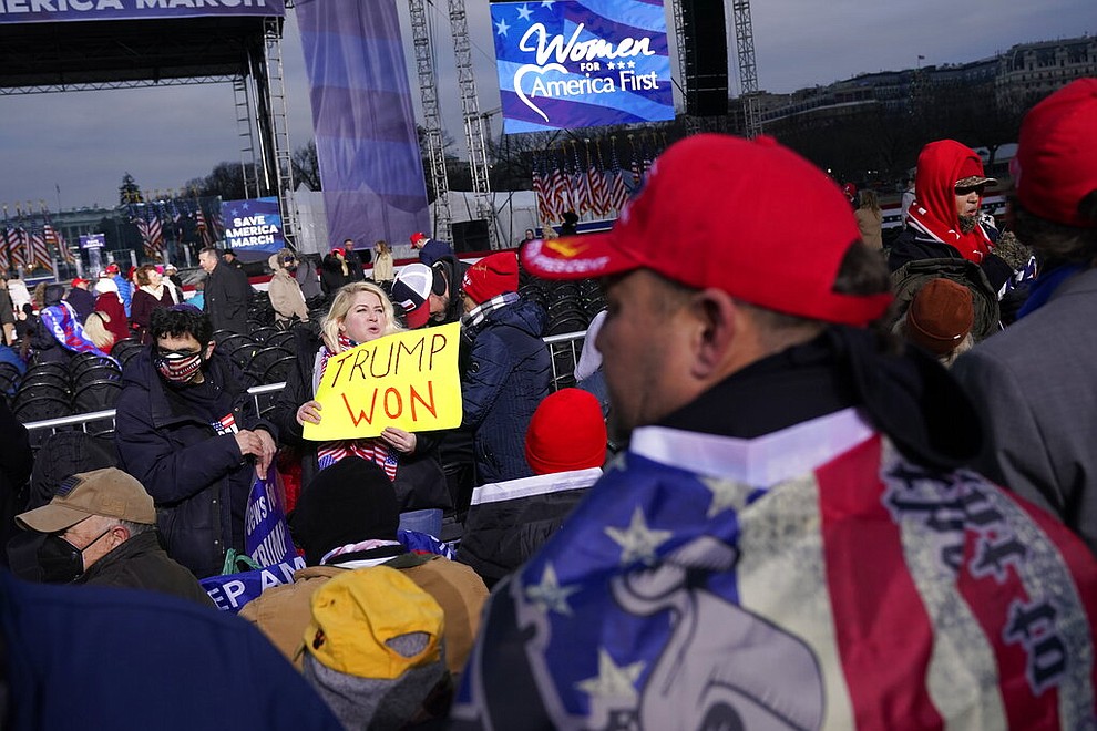 With the White House in the background, people arrive to listen to speakers Wednesday, Jan. 6, 2021, in Washington, at a rally in support of President Donald Trump called the "Save America Rally." (AP Photo/Jacquelyn Martin)