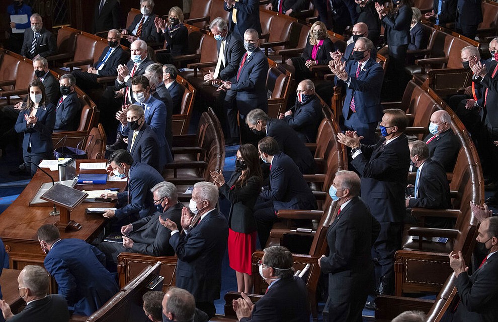 Republican members of Congress applaud as an objection is made to the slate of electors from the state of Arizona as a joint session of Congress as it convenes to count the Electoral College votes cast in November's election, at the Capitol in Washington, Wednesday, Jan. 6, 2021. Speaker of the House Nancy Pelosi, D-Calif., is at right. (Saul Loeb/Pool via AP)