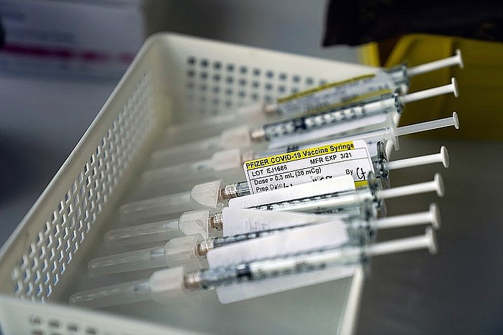 Syringes containing the Pfizer-BioNTech COVID-19 vaccine sit in a tray. (Jae C. Hong/AP, file)
