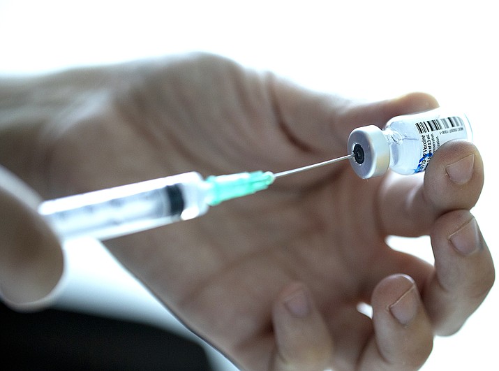 A healthcare worker prepares a dose of the Pfizer-BioNTech COVID-19 vaccine. (AP Photo/Esteban Felix)