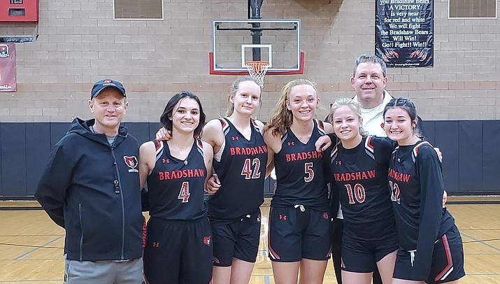 The 2020-2021 Bradshaw Mountain varsity girls basketball team’s seniors, from left, Carrie Perkins, Shannon Moore, Sierra Woolley, Brinlee Kidd and Macy Fournier. Coach Rick Haltom and assistant coach Scott Woolley, from left, flank the girls. (Courtesy/Melissa Chavez)