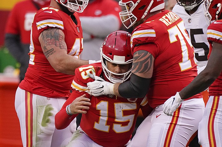 Kansas City Chiefs quarterback Patrick Mahomes (15) is helped off the field by teammate Mike Remmers, right, after getting injured during the second half of an NFL divisional round football game against the Cleveland Browns, Sunday, Jan. 17, 2021, in Kansas City. (Charlie Riedel/AP)