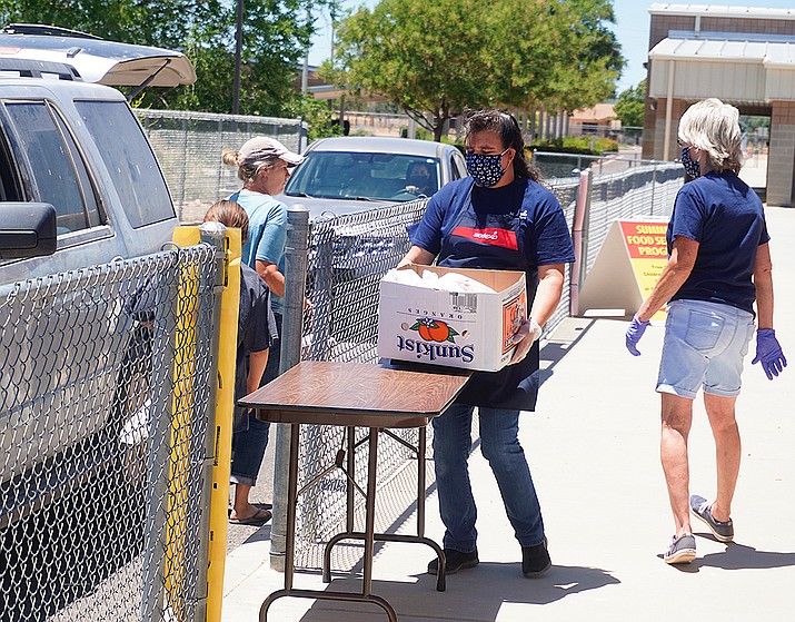 In this file July photo, Sodexo workers bring out boxes of meals to families as part of the Chino Valley Unified School District’s food program at Territorial Early Childhood Center, 1088 Mahan Lane. (Aaron Valdez/Review, file)