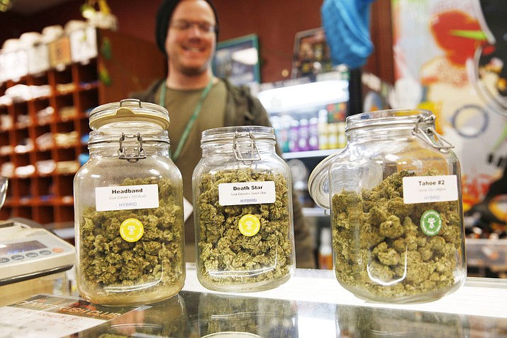 In this Nov. 27, 2015 photo, jars of marijuana buds sit on the counter at the Denver Kush Club in north Denver, Colorado. In Arizona, state health officials started accepting applications for recreational marijuana sites Tuesday, Jan. 19, 2021. (Dave Zalubowski/AP, file)