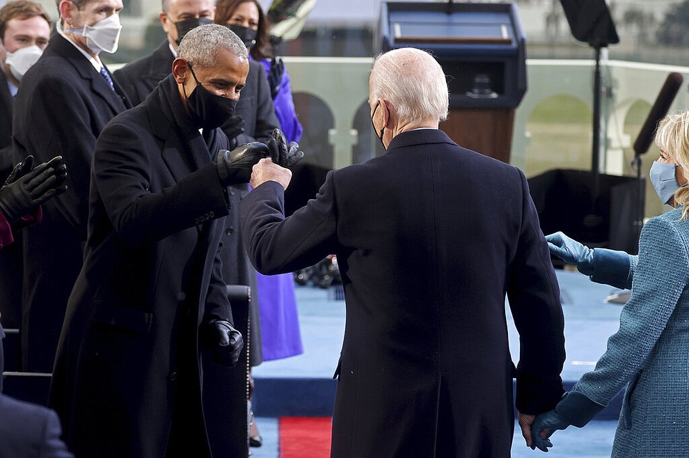 President-elect Joe Biden bumps fists with former President Barack Obama during Biden's inauguration, Wednesday, Jan. 20, 2021, at the U.S. Capitol in Washington./Pool Photo via AP)
