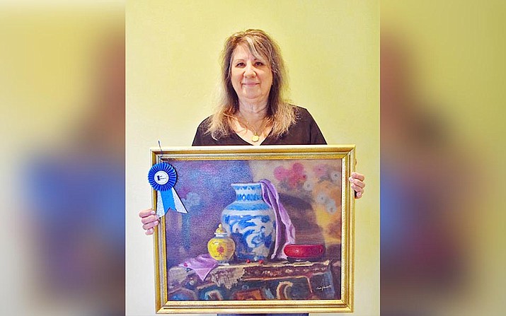 Clare Justine Bennet with winning painting. El Valle Artist Association will not hold its monthly meeting in January because of the current increase in COVID-19. Courtesy photo
