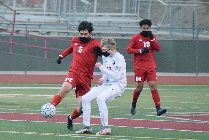 Mingus Union senior Jason Quiroz, No. 5, taps the ball away from a Bradshaw Mountain player during Friday’s season-opening, 4-1MUHS win. The Marauders are set to travel to Mohave on Wednesday and host Prescott at 5 p.m. Friday, Jan. 29. VVN/Jason W. Brooks