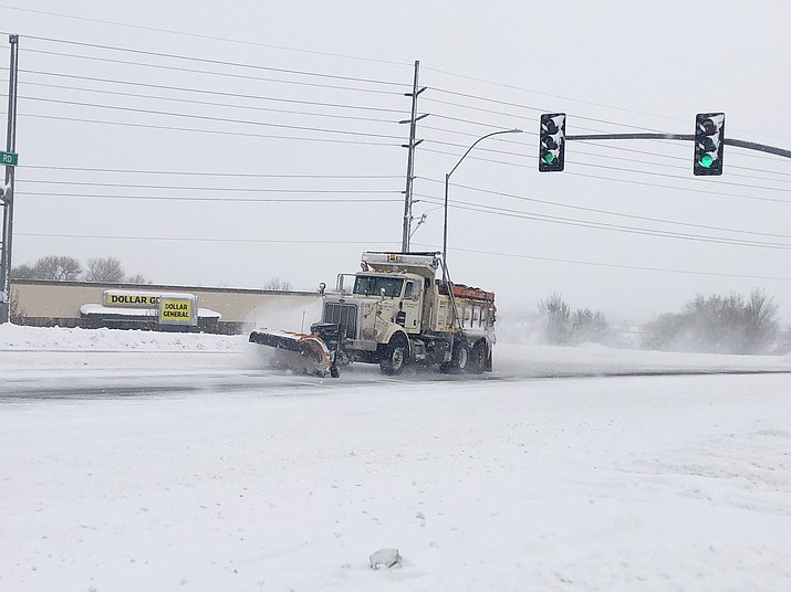 A city snow plow works to clear Willow Creek Road Tuesday morning, Jan. 26, 2021. Prescott Public Works Director Craig Dotseth said clearing the major arterials such as Willow Creek Road was the first priority for snow-removal crews. (Cindy Barks/Courier)