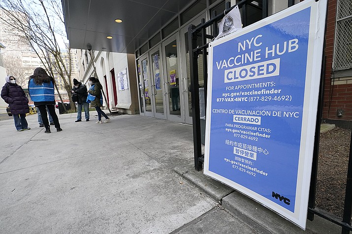 In this Jan. 21, 2021, file photo, people who had appointments to get COVID-19 vaccinations talk to New York City health care workers outside a closed vaccine hub in the Brooklyn borough of New York after they were told to come back in a week due to a shortage of vaccines. An increasing number of COVID-19 vaccination sites around the U.S. are canceling appointments because of vaccine shortages in a rollout so rife with confusion and unexplained bottlenecks. (Kathy Willens/AP)