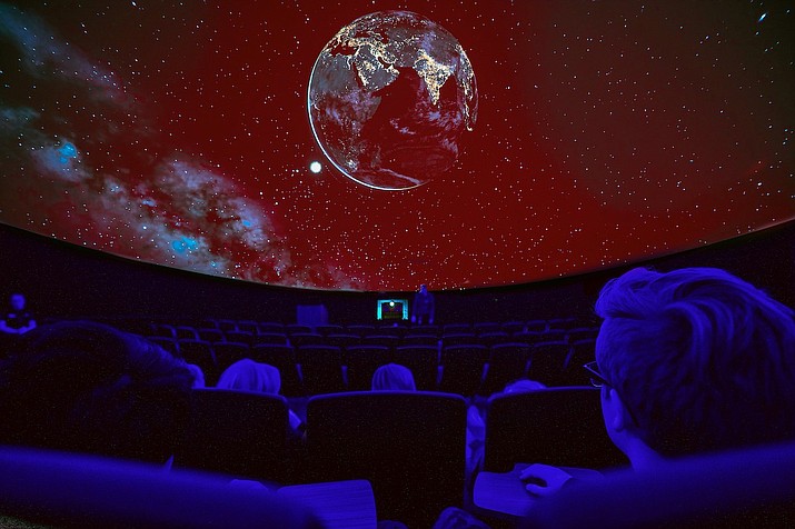 In this undated file photo, students watch a tour of the stars at the Jim and Linda Lee Planetarium on the campus of Embry-Riddle Aeronautical University in Prescott. ERAU will partner with the Prescott Unified School District to do a space-themed summer school. Pre-pandemic photo. Masks and physical distancing protocols are currently in place at ERAU. (ERAU/Courtesy)