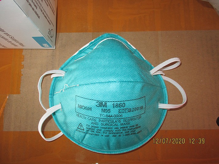 This December 2020 image provided by U.S. Immigration and Customs Enforcement (ICE) shows a counterfeit N95 surgical mask that was seized by ICE and U.S. Customs and Border Protection. Federal investigators are probing a massive counterfeit N95 mask operation sold in at least five states to hospitals, medical facilities, and government agencies and expect the number to rise significantly in coming weeks. The fake 3M masks are at best a copyright violations and at worst unsafe fakes that put unknowing health care workers at grave risk for coronavirus. And they are becoming increasingly difficult to spot. (ICE via AP)