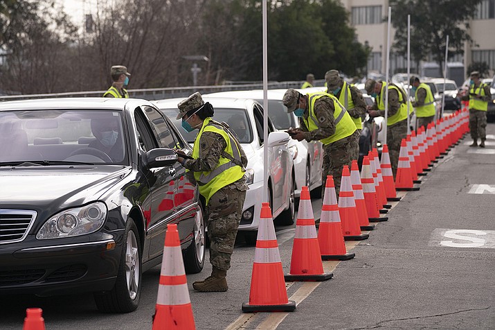 Members of the National Guard help motorists check in at a federally-run COVID-19 vaccination site set up on the campus of California State University of Los Angeles in Los Angeles, Tuesday, Feb. 16, 2021. (Jae C. Hong/AP)