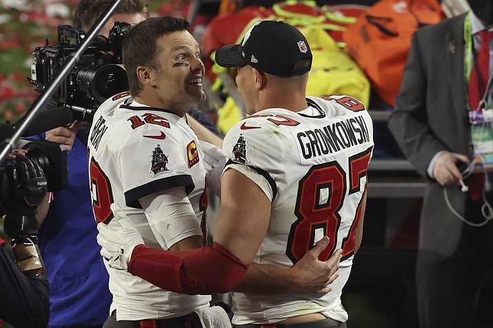 Tampa Bay Buccaneers quarterback Tom Brady (12) and Rob Gronkowski (87) celebrate their win in the NFL Super Bowl 55 football game against the Kansas City Chiefs Sunday, Feb. 7, 2021, in Tampa, Fla. The Buccaneers defeated the Chiefs 31-9 to win the Super Bowl. (Mark LoMoglio/AP file)