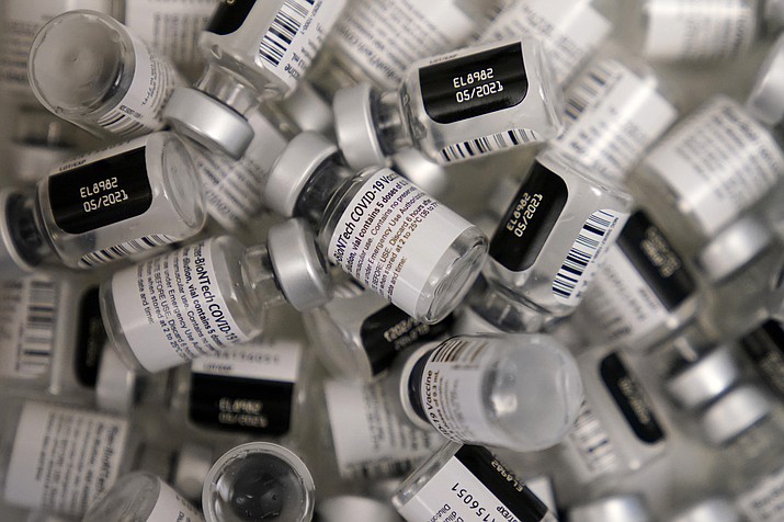 In this Friday, Jan. 22, 2021, file photo, empty vials of the Pfizer-BioNTech COVID-19 vaccine are seen at a vaccination center at the University of Nevada, Las Vegas. COVID-19 vaccine makers tell Congress to expect a big jump in the delivery of doses over the coming month. The companies insisted Tuesday, Feb. 23, at a hearing that they will be able to provide enough vaccine for most Americans by summer. (John Locher/AP, file)