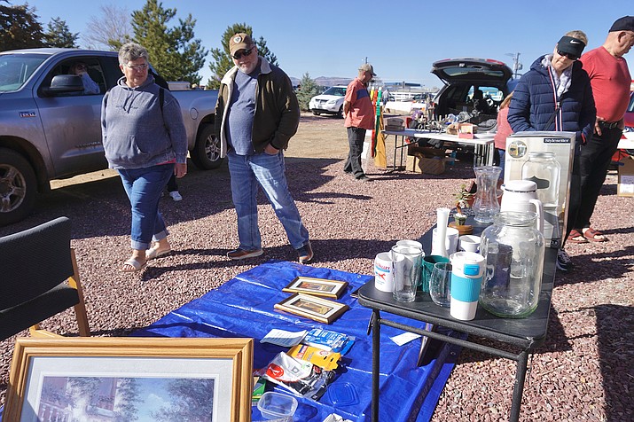 Attendees browse some of the tables at the Chino Valley Chamber of Commerce community yard sale on Saturday, Feb. 27, 2021, in Chino Valley. (Aaron Valdez/Review)