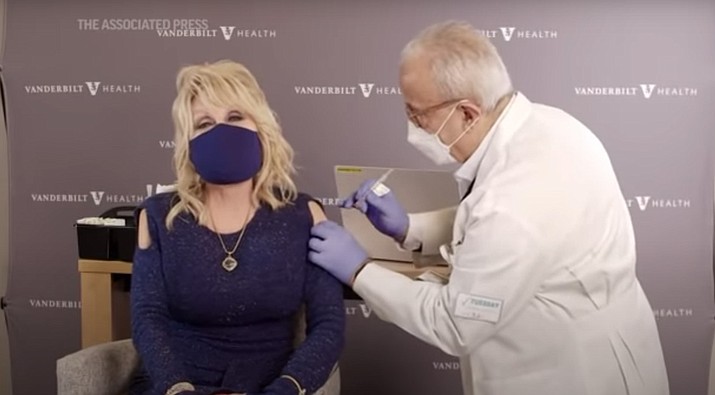 Dolly Parton, the Grammy-winning singer, actor and humanitarian posted a video on Tuesday, March 2, 2021, of her singing just before getting her COVID-19 vaccine shot. Parton donated $1 million to Vanderbilt University Medical Center in Nashville, Tennessee for coronavirus research. (Image from video/AP))