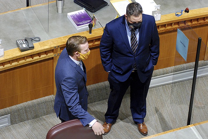 New Mexico Republican state Senate Minority Leader Gregory Baca of Belen, right, and Sen. Cliff Pirtle, R-Roswell, stand on the Senate floor on Tuesday, Jan. 19, 2021, in Santa Fe, N.M., on the first day of a 60-day legislative session. (Morgan Lee/AP)