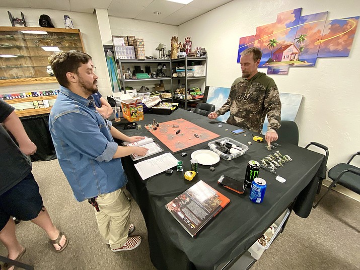 Customers at Alpha Fortress Games play a board game during the store’s ribbon-cutting ceremony on Wednesday, March 3, 2021, in Chino Valley. (Aaron Valdez/Courier)