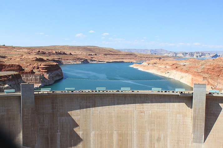 This Aug. 21, 2019 image shows Glen Canyon Dam near Page, Arizona, holding back Lake Powell. A plan by Utah could open the door to the state pursuing an expensive pipeline that critics say could further deplete the lake, which is a key indicator of the Colorado River's health. (AP Photo/Susan Montoya Bryan)