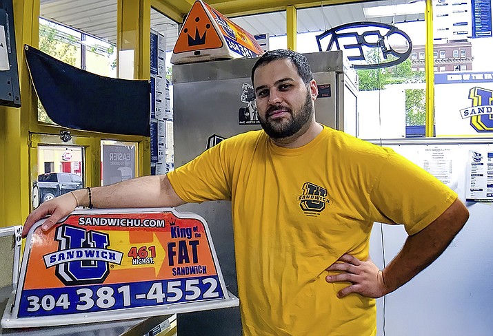 This April 2017, file photo photo shows George Tanios at his sandwich shop in Morgantown, W.Va. U.S. officials have arrested and charged Tanios and a Pennsylvania man with assaulting U.S. Capitol Police officer Brian Sicknick with bear spray during the Jan. 6, 2021, riot in Washington. (Andrew Spellman, The Daily Athenaeum via AP)
