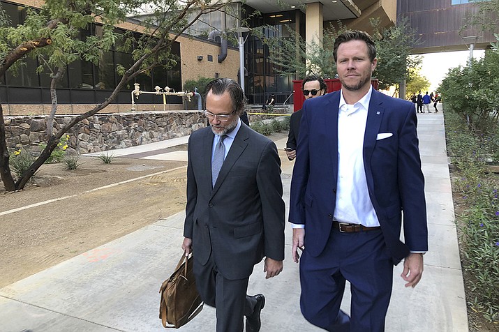 In this Nov. 5, 2019, file photo, then-Maricopa County Assessor Paul Petersen, right, and his attorney, Kurt Altman, leave a court hearing in Phoenix. Petersen is scheduled on Friday, March 19, 2021, to receive the second of three prison sentences for convictions stemming from his acknowledged operation of an illegal adoption scheme involving women from the Marshall Islands. (Jacques Billeaud, AP File)