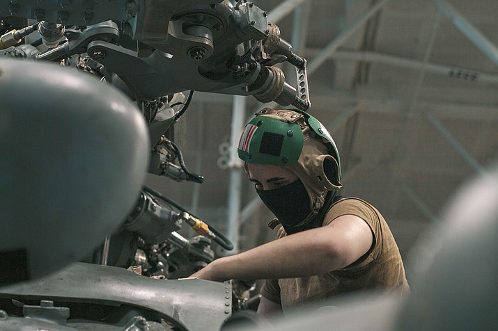 U.S. Navy Aviation Structural Mechanic 3rd Class Rachel Womack, from Prescott, is assigned to the “Eightballers” of Helicopter Sea Combat Squadron (HSC) 8. In this photo, Womack wipes the rotor head of an MH-60S Sea Hawk in the hangar bay of the aircraft carrier USS Theodore Roosevelt (CVN 71) March 16, 2021. The Theodore Roosevelt Carrier Strike Group is on a scheduled deployment to the U.S. 7th Fleet area of operations in the Indian Ocean. As the U.S. Navy’s largest forward-deployed fleet, 7th Fleet routinely operates and interacts with 35 maritime nations while conducting missions to preserve and protect a free and open Indo-Pacific Region. With more than 90% of all trade traveling by sea, and 95% of the world’s international phone and internet traffic carried through fiber optic cables lying on the ocean floor, Navy officials continue to emphasize that the prosperity and security of the United States is directly linked to a strong and ready Navy. (Mass Communication Specialist Seaman Alexander B. Williams)