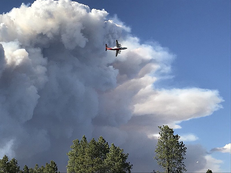An air tanker flies near the Mangum Fire smoke column in June 2020.