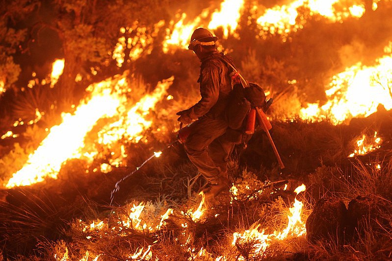 A firefighter backburns on the 2020 Mangum Fire.