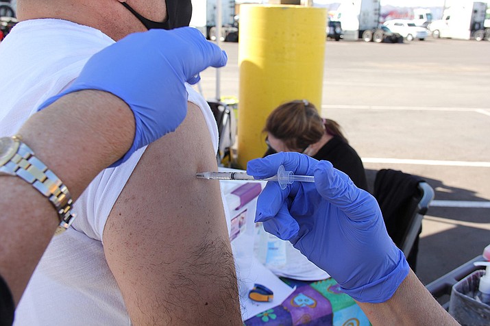 An essential worker gets vaccinated at a special event Bashas’ food stores set up for its workers in Chandler. (Travis Robertson/Cronkite News)