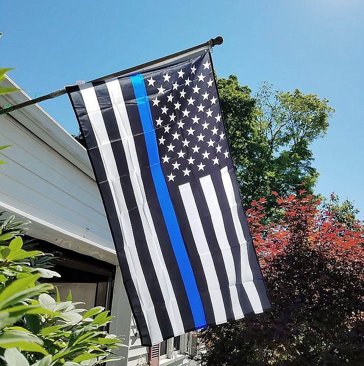 The Thin Blue Line flag, which honors and remembers the sacrifices of police officers in the United States, features a solid blue stripe running across the middle of a black-and-white American flag. (thinbluelineusa.com / Courtesy)