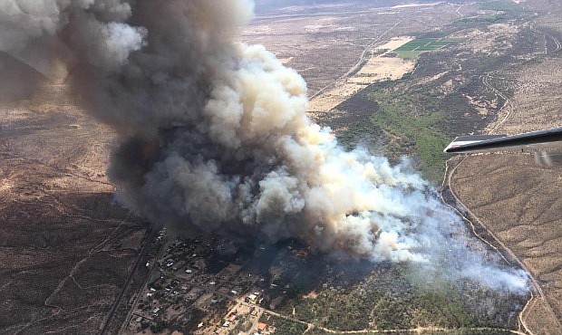 Dudleyville in south-central Arizona remained under an evacuation notice April 9 after crews and air tankers stopped the growth of a wildfire that burned at least 12 homes. (Photo/Inciweb)