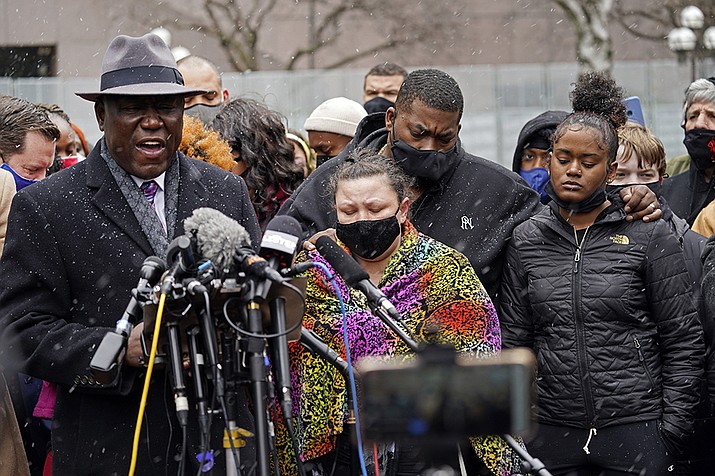 Katie Wright, center, the mother of Daunte Wright, and other family and friends gather during a news conference Tuesday, April 13, 2021, in Minneapolis as family attorney Ben Crump, left, speaks. Daunte Wright, 20, was shot and killed by police Sunday after a traffic stop in Brooklyn Center, Minn. (Jim Mone/AP)
