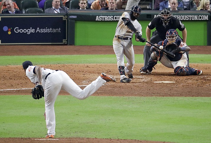 Boston Red Sox's Jackie Bradley Jr., hits a two-run home run off Houston Astros pitcher Josh James during the sixth inning in Game 4 of a baseball American League Championship Series in Houston, in this Wednesday, Oct. 17, 2018, file photo. Major League Baseball wants to see if moving back the pitcher's mound will increase offense. MLB will experiment with a 12-inch greater distance between the mound and home plate during a portion of the Atlantic League season in an effort to decrease strikeouts and increase offense. The pitching rubber will be moved back to 61 feet, 6 inches starting Aug. 3. (Lynne Sladky, AP File)
