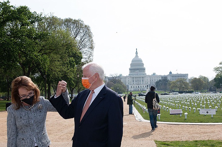 Former Arizona Rep. Gabrielle Giffords shakes hands with Rep. Mike Thompson, D-Calif., after a news conference in which she joined Democratic lawmakers who called on Congress to pass a background checks bill. (Ryan Knappenberger/Cronkite News)