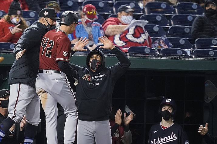 Arizona Diamondbacks' Andrew Young, second from left, celebrates his grand slam with his teammates during the second inning of a baseball game against the Washington Nationals at Nationals Park, Thursday, April 15, 2021, in Washington. (Alex Brandon/AP)