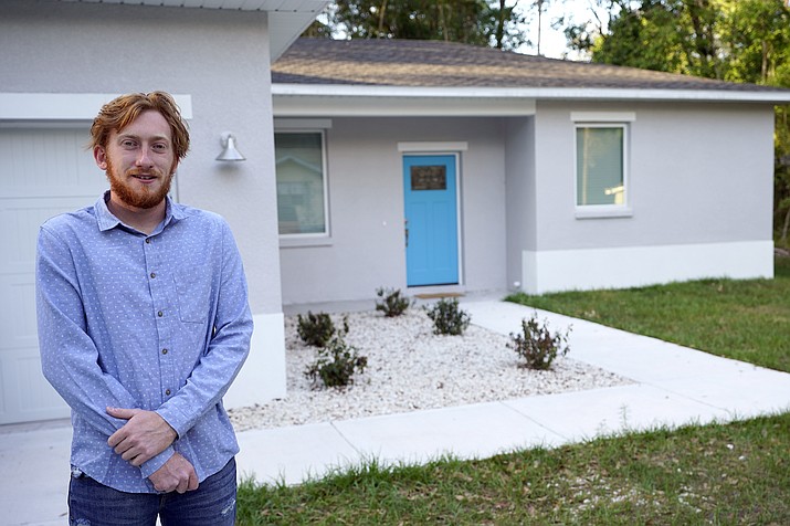 First-time buyer Kevin Muglach stands in front of his new home, Tuesday, April 6, 2021, in Orange City, Fla. Homebuyers are facing the most competitive U.S. housing market in decades this spring, as surging prices and a record-low number of homes for sale narrow the already difficult path to home ownership for many Americans. (John Raoux/AP)