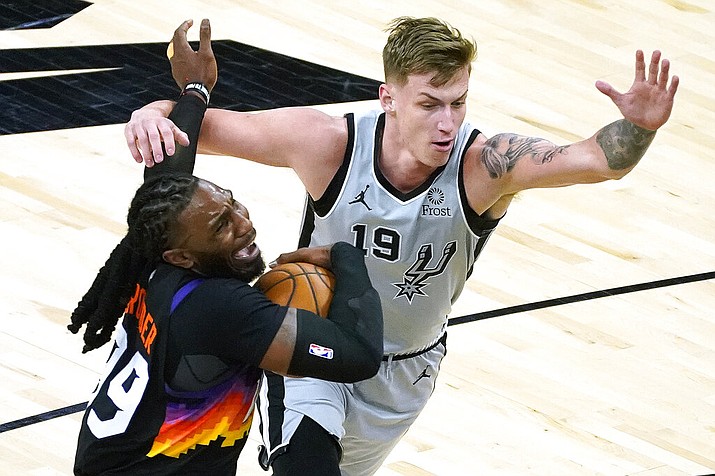 Phoenix Suns forward Jae Crowder gets fouled by San Antonio Spurs forward Luka Samanic (19) during the second half of an NBA basketball game Saturday, April 17, 2021, in Phoenix. (AP Photo/Rick Scuteri)