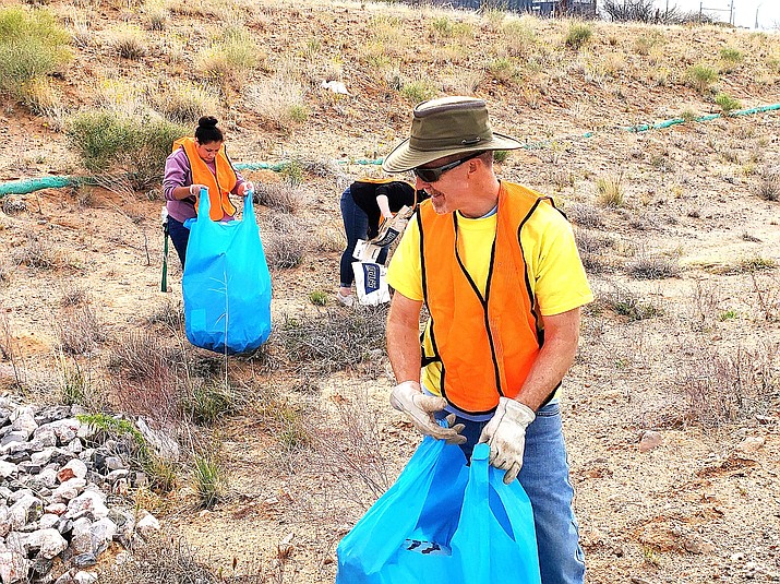Rotarians of all ages pick up trash on Saturday, April 17 along State Route 260. Courtesy photo
