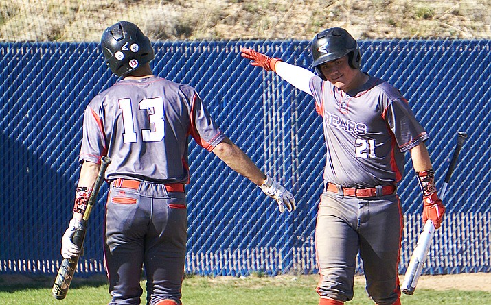 Bradshaw Mountain baseball’s Josh Grant (13) and Blair Hillig (21) celebrate after the Bears scored a run during a game against Prescott on Tuesday, April 20, 2021, in Prescott. The Bears defeated the Badgers 11-1. (Aaron Valdez/Courier)