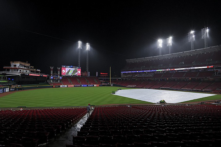 A tarp covers the infield during a rain delay in the eighth inning of a baseball game between the Arizona Diamondbacks and the Cincinnati Reds in Cincinnati, Tuesday, April 20, 2021. (Aaron Doster/AP)