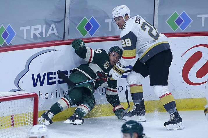 Vegas Golden Knights left wing William Carrier (28) takes down Minnesota Wild defenseman Jared Spurgeon (46) in the first period during an NHL hockey game, Monday, May 3, 2021, in St. Paul, Minn. (Andy Clayton-King/AP)