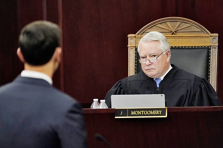 An attorney gives oral arguments as Arizona Supreme Court Justice William G. Montgomery listens April 20, 2021, in Phoenix. The justices on Tuesday, May 4, 2021, said there’s nothing wrong with a 2006 law which requires those who are convicted of certain serious criminal traffic offenses to provide restitution. (Matt York/AP, file)