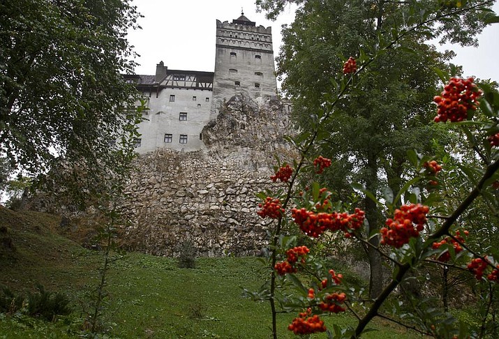 In this Saturday, Oct. 8, 2011 file picture, the Gothic Bran Castle, better known as Dracula Castle, is seen on a rainy day in Bran, in Romania's central Transylvania region. Romanian authorities have set up a COVID-19 vaccination center in a medieval building in Bran, not far from the castle, as a means to encourage people to vaccinate and also to boost tourism which has decreased in the area as a result of the pandemic. (AP Photo/Vadim Ghirda, File)