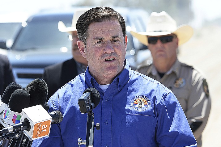 In this April 21, 2021, file photo, Arizona Gov. Doug Ducey addresses the media at the U.S-Mexico border in Yuma, Ariz. Ducey on Thursday, May 13, 2021, joined a growing number of Republican governors who are stopping payment of an extra $300 per week in pay for unemployed workers paid for by a federal virus relief package to force people to return to work. (Randy Hoeft/The Yuma Sun via AP, File)
