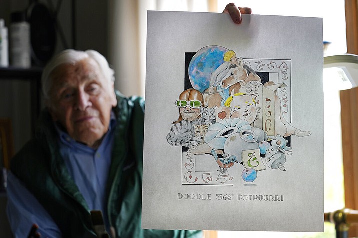Artist Robert Seaman holds up the 365th daily doodle sketch in his room at an assisted living facility Monday, May 10, 2021, in Westmoreland, N.H. Seaman, who moved into the facility weeks before the COVID-19 pandemic shut down his outside world in 2020, recently completed his 365th daily sketch, or what he calls his "Covid Doodles," since being isolated due to the virus outbreak. (AP Photo/Charles Krupa)