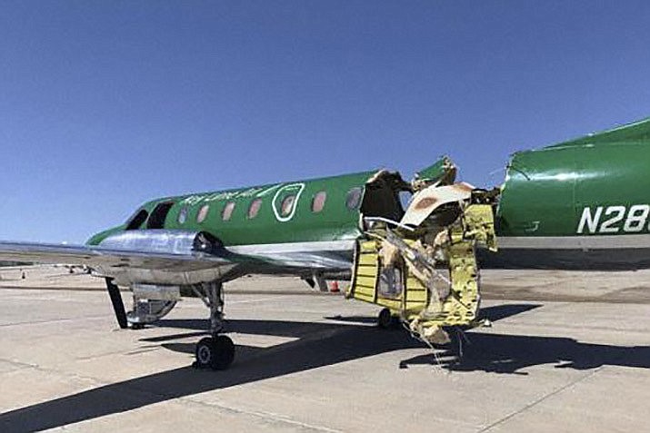 This image from CBS Denver shows a Key Lime Air Metroliner that landed safely at Centennial Airport after a mid-air collision near Denver on Wednesday, May 12, 2021. Federal officials say two airplanes collided but that there are no injuries. The collision between a twin-engine Fairchild Metroliner and a single-engine Cirrus SR22 happened as both planes were landing.(CBS Denver via AP)